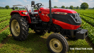 Solis 4215 E tractor with durable build, wide tyres, and powerful engine working in a farm field.